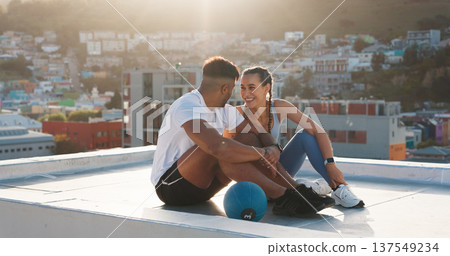 Fitness, rest and happy couple outdoor for exercise, workout or training together on a city building rooftop. Man and woman on urban break with medicine ball, conversation or health and wellness Fitness, rest and happy couple outdoor for exercise, workout or training together on a city building rooftop. Man and woman on urban break with medicine ball, conversation or health and wellness 137549234