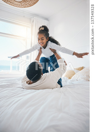 Airplane, fun and bedroom with family laughing at home with a happy father and young girl together. Smile, bonding and love of a dad and child on a bed with plane game in a house with care and joy Airplane, fun and bedroom with family laughing at home with a happy father and young girl together. Smile, bonding and love of a dad and child on a bed with plane game in a house with care and joy 137549328