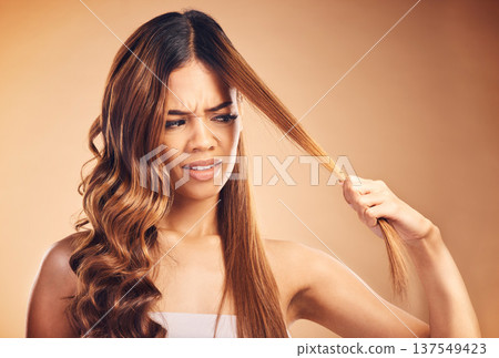 Hair, problem and women with crisis and frustrated from salon treatment and Brazilian fail. Studio, brown background and angry model with damage from split ends and upset of bad and messy haircut Hair, problem and women with crisis and frustrated from salon treatment and Brazilian fail. Studio, brown background and angry model with damage from split ends and upset of bad and messy haircut 137549423