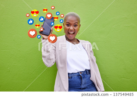 Portrait, excited black woman and phone emojis, social media icons and thumbs up notification. Smartphone communication, like opinion vote and African user show feedback on green background wall Portrait, excited black woman and phone emojis, social media icons and thumbs up notification. Smartphone communication, like opinion vote and African user show feedback on green background wall 137549485