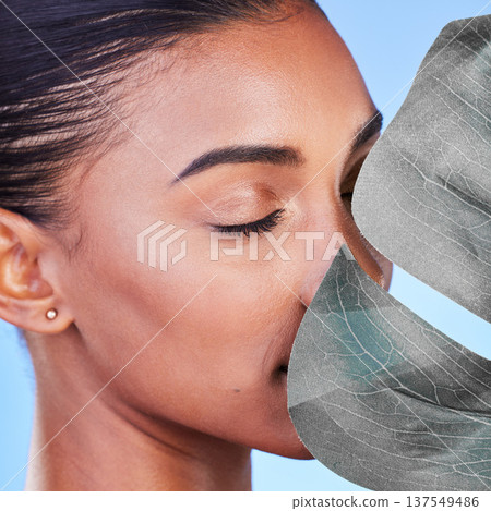 Skincare, beauty and a woman with a plant on a blue background for wellness, health and a glow. Closeup, spa and a girl or face of model with a leaf for facial luxury, cosmetics or sustainable makeup Skincare, beauty and a woman with a plant on a blue background for wellness, health and a glow. Closeup, spa and a girl or face of model with a leaf for facial luxury, cosmetics or sustainable makeup 137549486