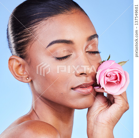 Rose, face and skincare of woman in studio for eco cosmetics, natural wellness or blue background. Indian model, flowers and eyes closed for vegan beauty, sustainable dermatology and floral aesthetic Rose, face and skincare of woman in studio for eco cosmetics, natural wellness or blue background. Indian model, flowers and eyes closed for vegan beauty, sustainable dermatology and floral aesthetic 137549681