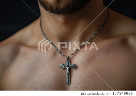 Christian pectoral cross hanging from chain on believer's chest in a solemn moment Christian pectoral cross hanging from chain on believer's chest in a solemn moment 137549986