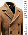 Modern warm classic coat displayed on a clothes mannequin against a white background 137549988