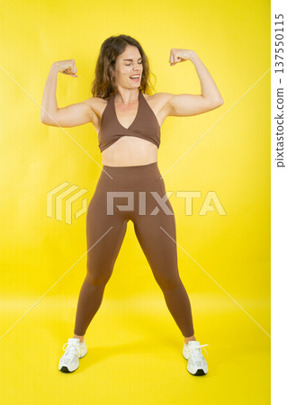 Woman flexing arm muscles showing physical strength Woman flexing arm muscles showing physical strength 137550115