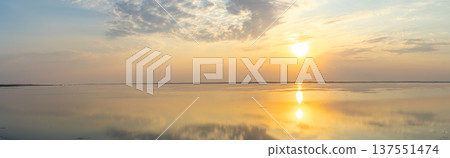 Golden sunset over the Tuzlivsky estuaries in Lebedivka, Ukraine, creating a peaceful and picturesque natural landscape. Golden sunset over the Tuzlivsky estuaries in Lebedivka, Ukraine, creating a peaceful and picturesque natural landscape. 137551474