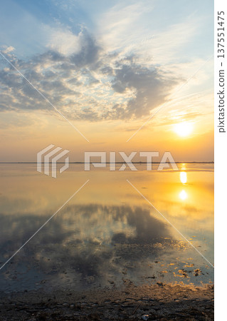 Golden sunset over the Tuzlivsky estuaries in Lebedivka, Ukraine, creating a peaceful and picturesque natural landscape. Golden sunset over the Tuzlivsky estuaries in Lebedivka, Ukraine, creating a peaceful and picturesque natural landscape. 137551475