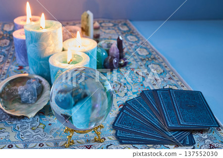Fortune telling setup with crystal ball, tarot cards, and candles Fortune telling setup with crystal ball, tarot cards, and candles 137552030