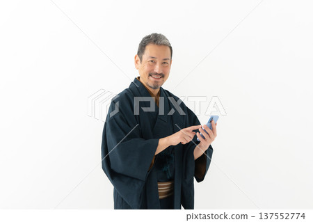 Man wearing kimono, smartphone, smartphone Man wearing kimono, smartphone, smartphone 137552774