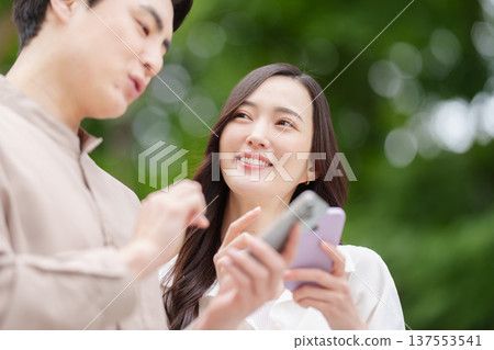 A couple searching for a destination on their smartphone 137553541