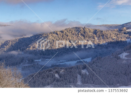 Looking out over the snowcapped valley in the golden hour Looking out over the snowcapped valley in the golden hour 137553692