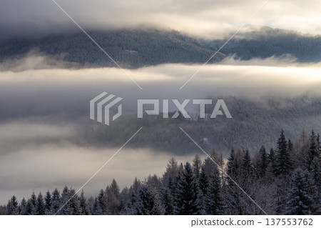 Sunrise makes a breakthrough in the mist between the mountains 137553762