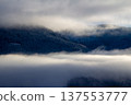 Sunrise makes a breakthrough in the mist between the mountains 137553777