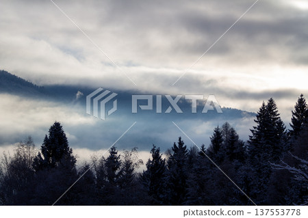 Sunrise makes a breakthrough in the mist between the mountains 137553778