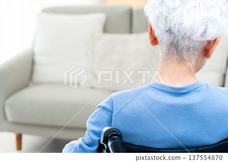 Rear view of a senior woman sitting in a wheelchair Rear view of a senior woman sitting in a wheelchair 137554870