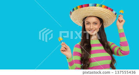 Cinco de Mayo, A young woman holds maracas while wearing a sombrero Cinco de Mayo, A young woman holds maracas while wearing a sombrero 137555436