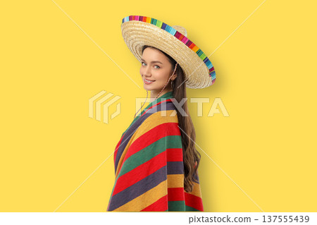 Cinco de Mayo, A young woman wears a sombrero and a colorful blanket Cinco de Mayo, A young woman wears a sombrero and a colorful blanket 137555439