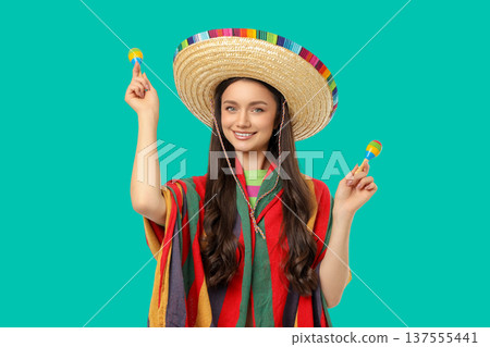 Cinco de Mayo, Smiling woman in sombrero shakes maracas 137555441