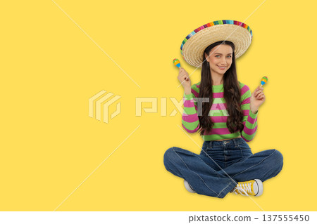 Cinco de Mayo, Young woman in sombrero and festive clothes sits 137555450