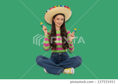 Cinco de Mayo, Young woman joyfully celebrating with maracas 137555451