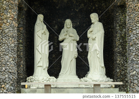Statues of three figures stand in a stone temple in Bali Statues of three figures stand in a stone temple in Bali 137555515