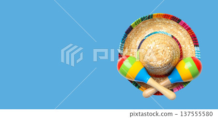 Cinco de Mayo, Maracas and sombrero sit on a blue surface Cinco de Mayo, Maracas and sombrero sit on a blue surface 137555580