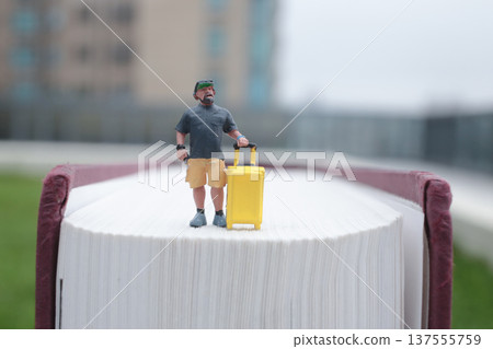 Tiny Figure Stands Confidently Beside Upright Yellow Suitcase Tiny Figure Stands Confidently Beside Upright Yellow Suitcase 137555759