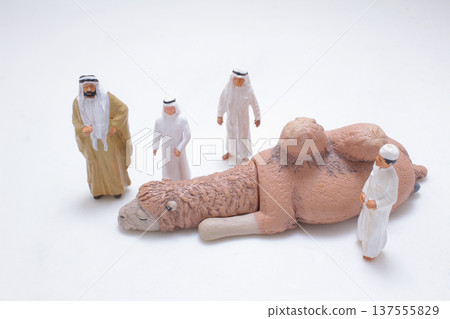 Miniature camels displayed before group of desert figures 137555829