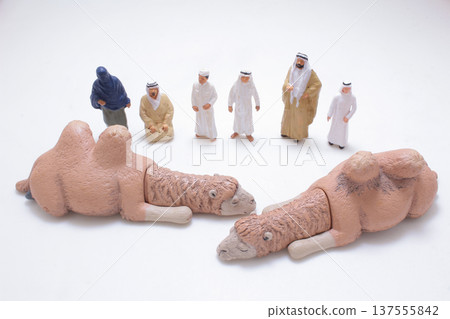 Miniature camels displayed before group of desert figures 137555842