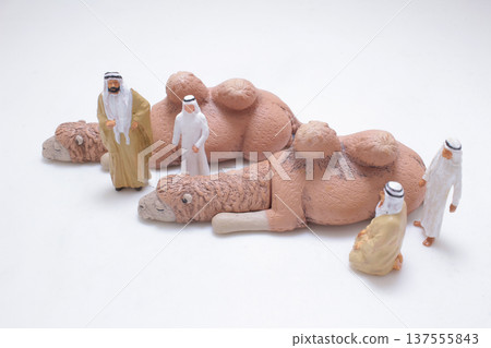 Miniature camels displayed before group of desert figures 137555843