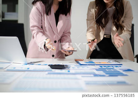 Business people meeting at office writing notes about sticky notes Laptop,tablet Planning and Brainstorming Strategies of Colleagues Business people meeting at office writing notes about sticky notes Laptop,tablet Planning and Brainstorming Strategies of Colleagues 137556185