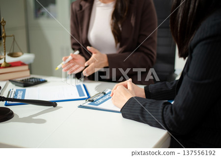 Compassionate lawyer providing legal consultation and emotional support to client, concept of dispute resolution, corporate law, contract advice Compassionate lawyer providing legal consultation and emotional support to client, concept of dispute resolution, corporate law, contract advice 137556192