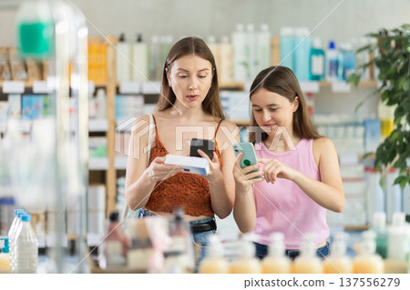 Woman with daughter scanning qr code of ointment 137556279