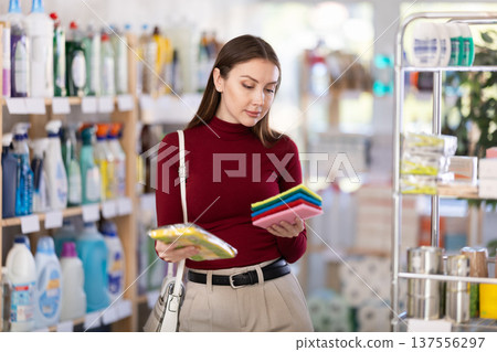 customer chooses sponges and rags for the kitchen 137556297