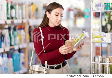 Young woman chooses clothespins in store Young woman chooses clothespins in store 137556300