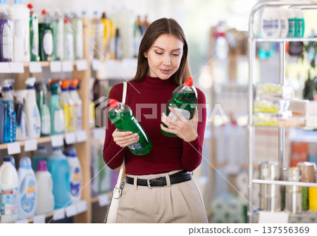 Young woman chooses dishwashing detergent in store 137556369