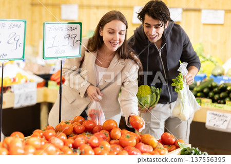 Married couple choose cauliflower together at a grocery supermarket. Names of vegetables in spanish Married couple choose cauliflower together at a grocery supermarket. Names of vegetables in spanish 137556395