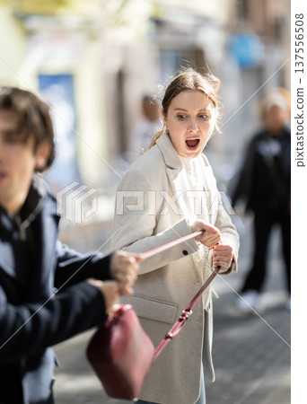 Thief steals girls handbag and runs away with stolen property 137556508