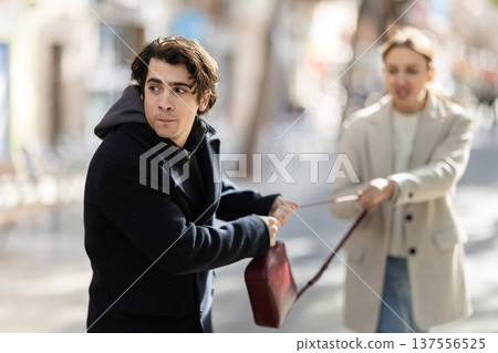 Thief steals girls handbag and runs away with stolen property 137556525