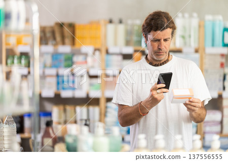 Adult man scanning qr code of pills 137556555