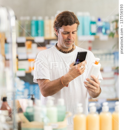 Adult man scanning qr code of cream 137556593