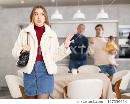 Two men quarreling with young woman Two men quarreling with young woman 137556654