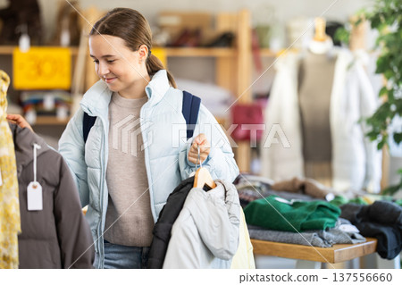 teenage girl will choose a down jacket 137556660