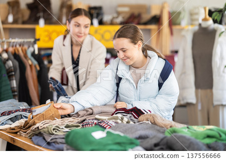 woman with a teenage daughter choosing woolen pants 137556666
