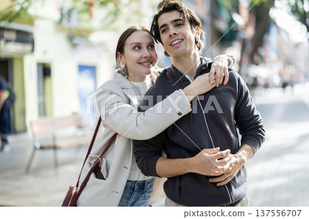 Young couple hugging each other on city street Young couple hugging each other on city street 137556707