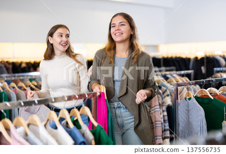 Two happy female friends are shopping in clothing store. Shopping young ladies 137556735