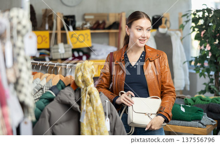 Adult woman choosing handbag in clothing store 137556796