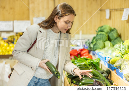 Girl shopping, client buy elect zucchini Girl shopping, client buy elect zucchini 137556823