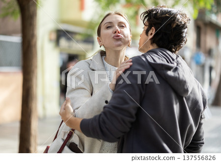 Guy and girl hug, say goodbye, end of date Guy and girl hug, say goodbye, end of date 137556826