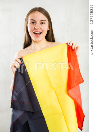 Portrait of happy young woman of Belgium match waving national flag Portrait of happy young woman of Belgium match waving national flag 137556832